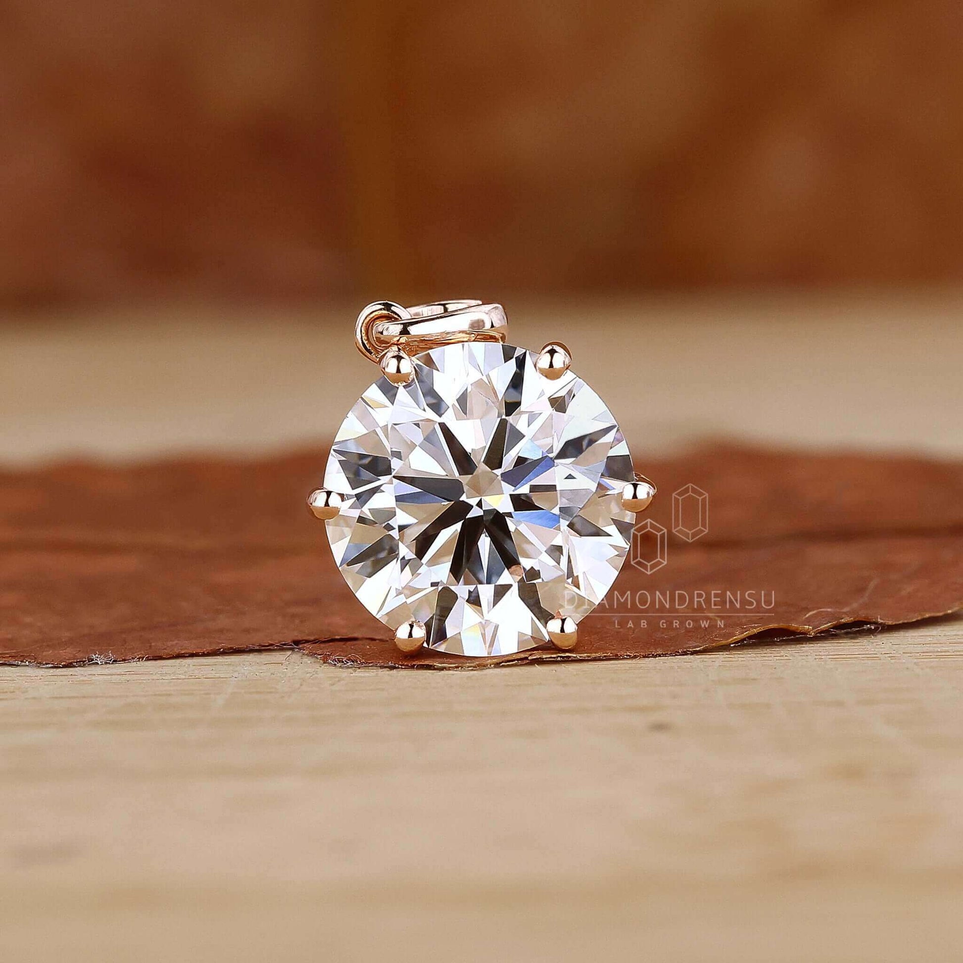 Close-up of a round diamond pendant in a gold setting