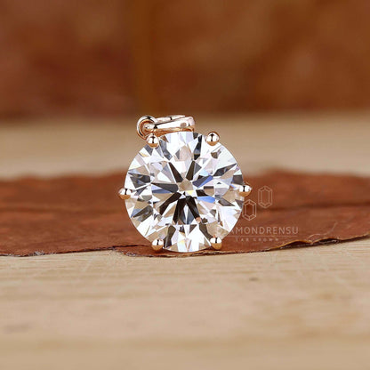 Close-up of a round diamond pendant in a gold setting