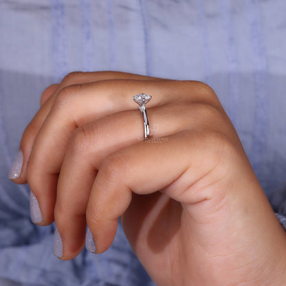 Model showcasing a round solitaire diamond ring with diamond bridge accent