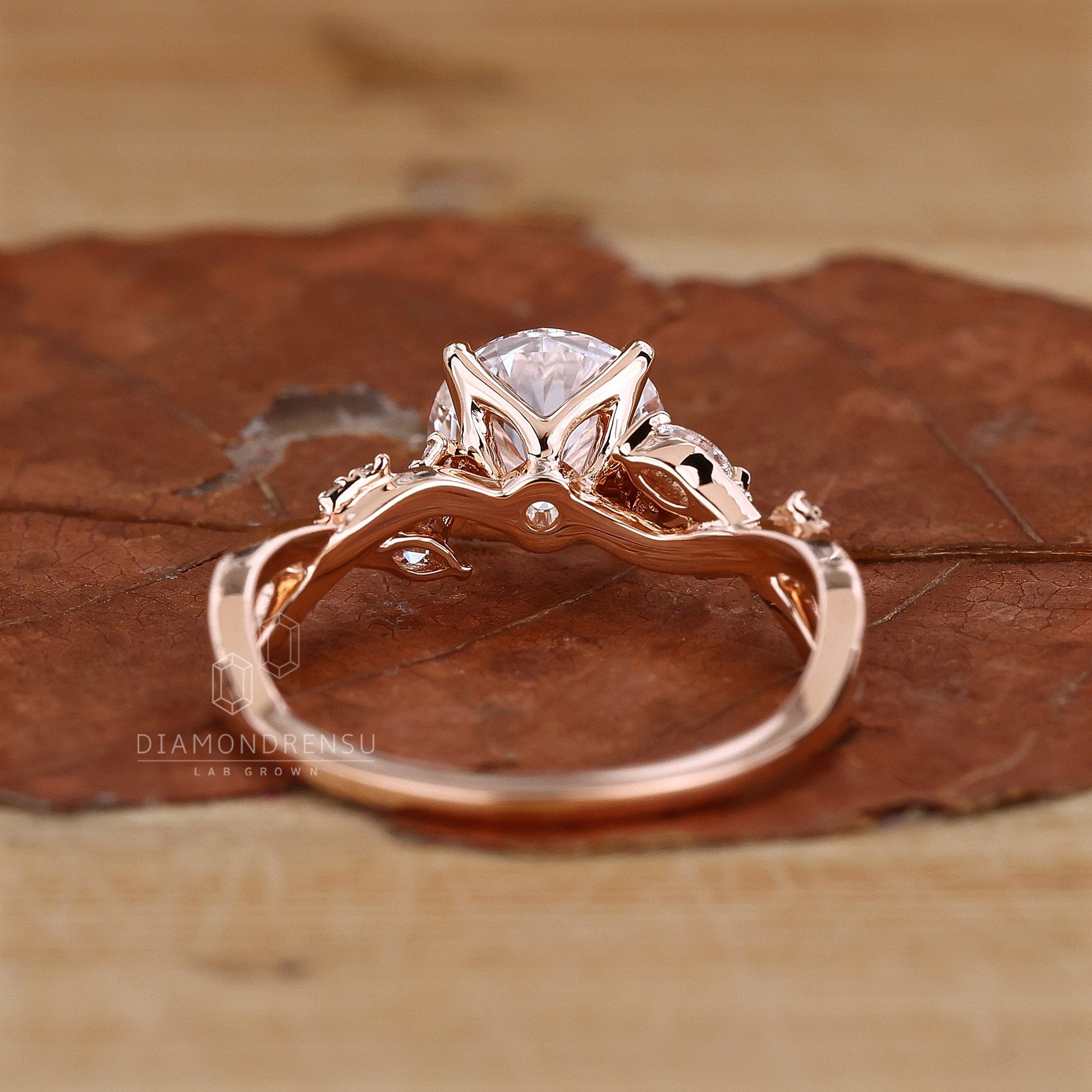 Handmade nature-inspired ring with a round cut diamond and twisted pave band