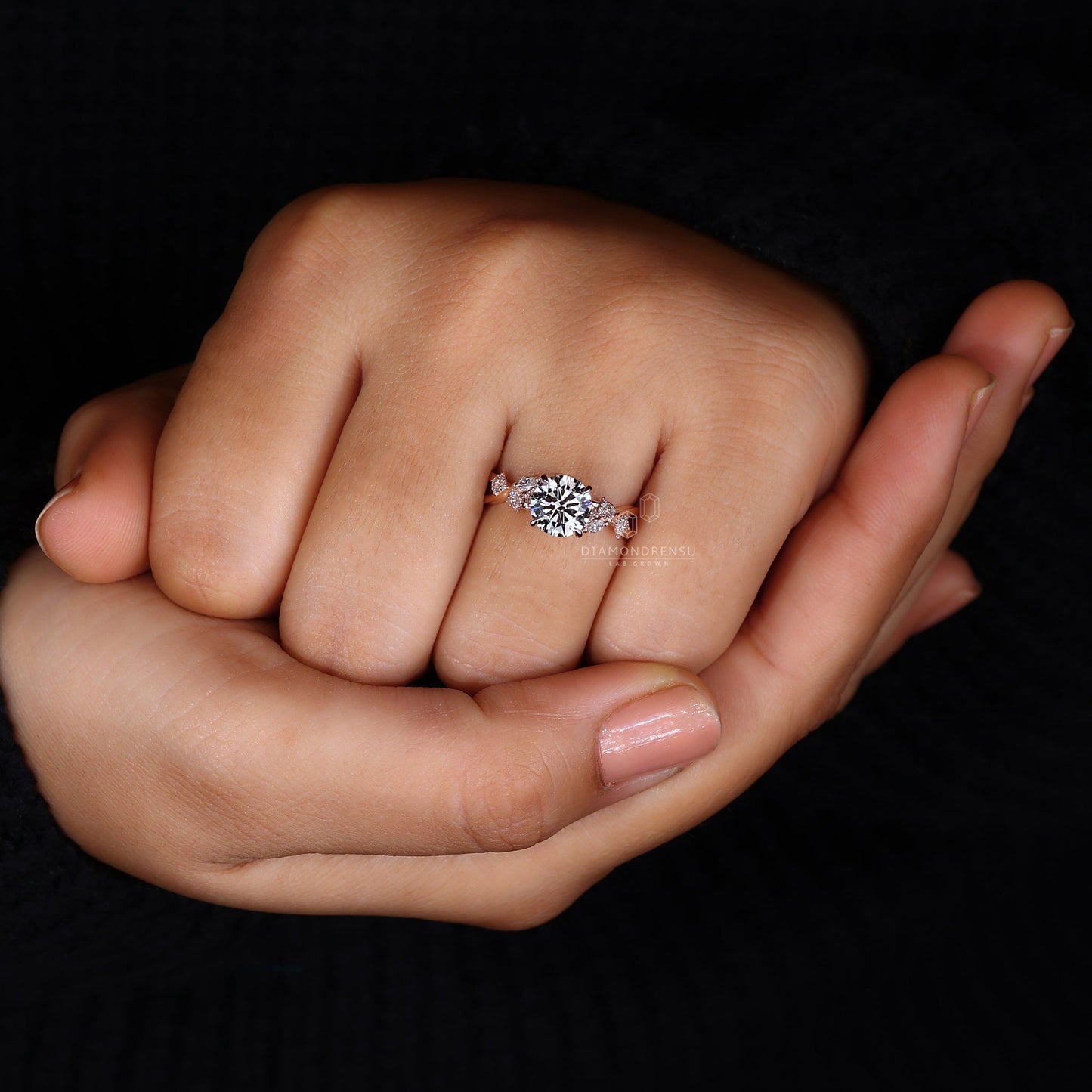 Model showcasing a diamondrensu nature-inspired ring with a round brilliant cut diamond and twisted pave band