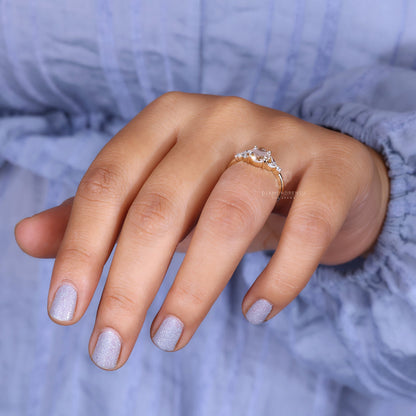 A model's hand featuring a round rose cut diamond engagement ring.