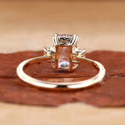 Detailed view of an emerald cut diamond in a classic three stone ring setting