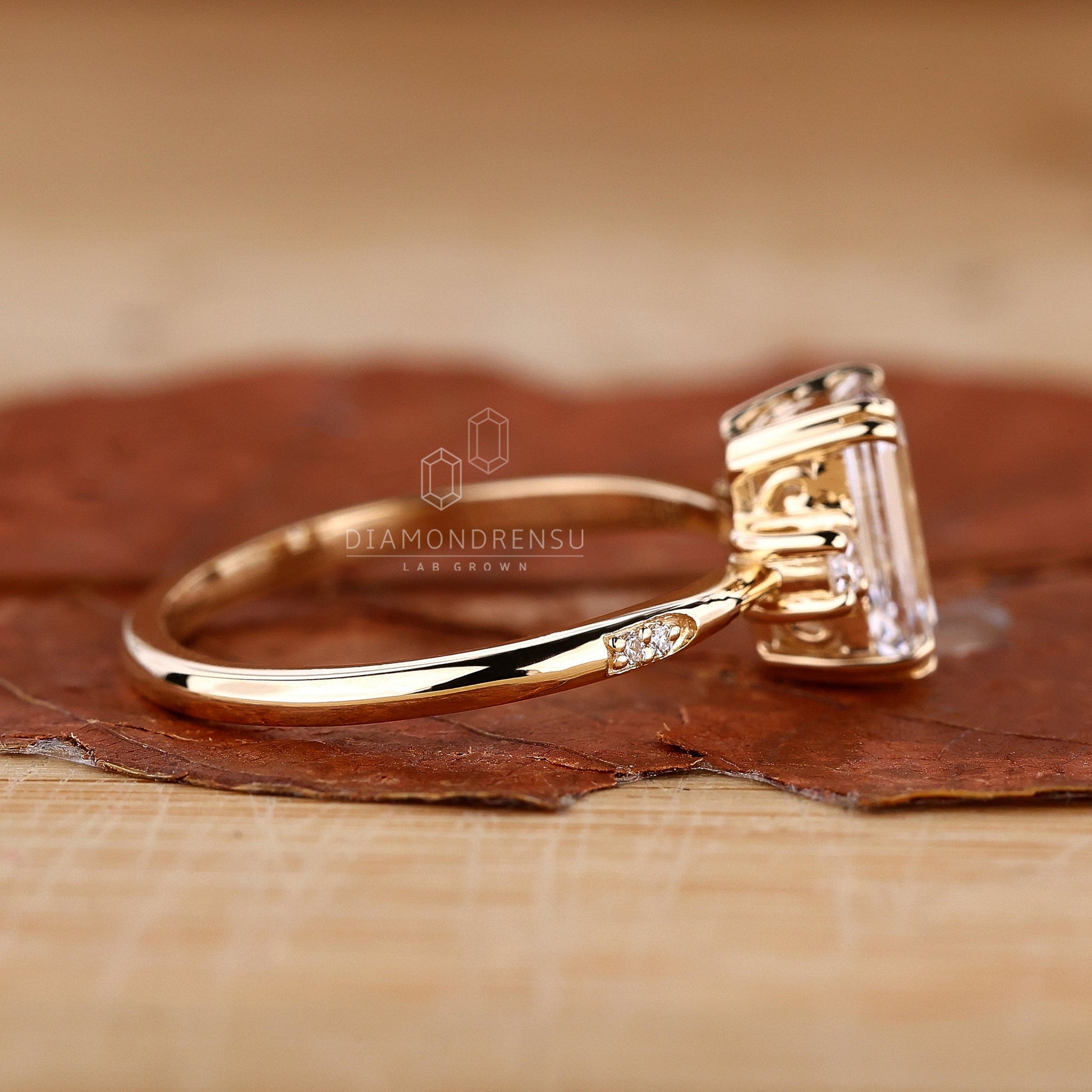 Elegant emerald cut ring on a floral background, showcasing the gem's clarity