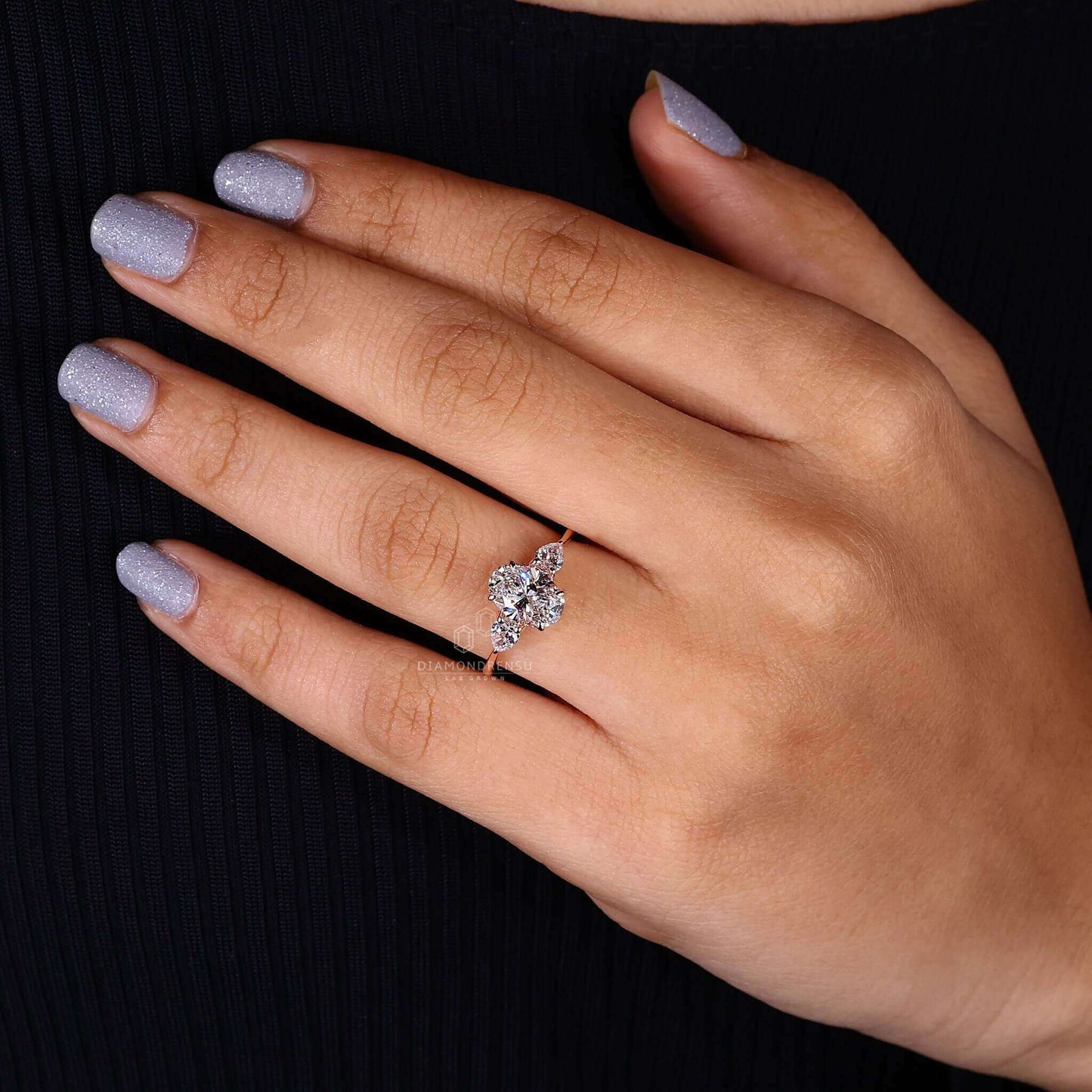 Model showing off an oval lab-grown diamond ring with claw prongs