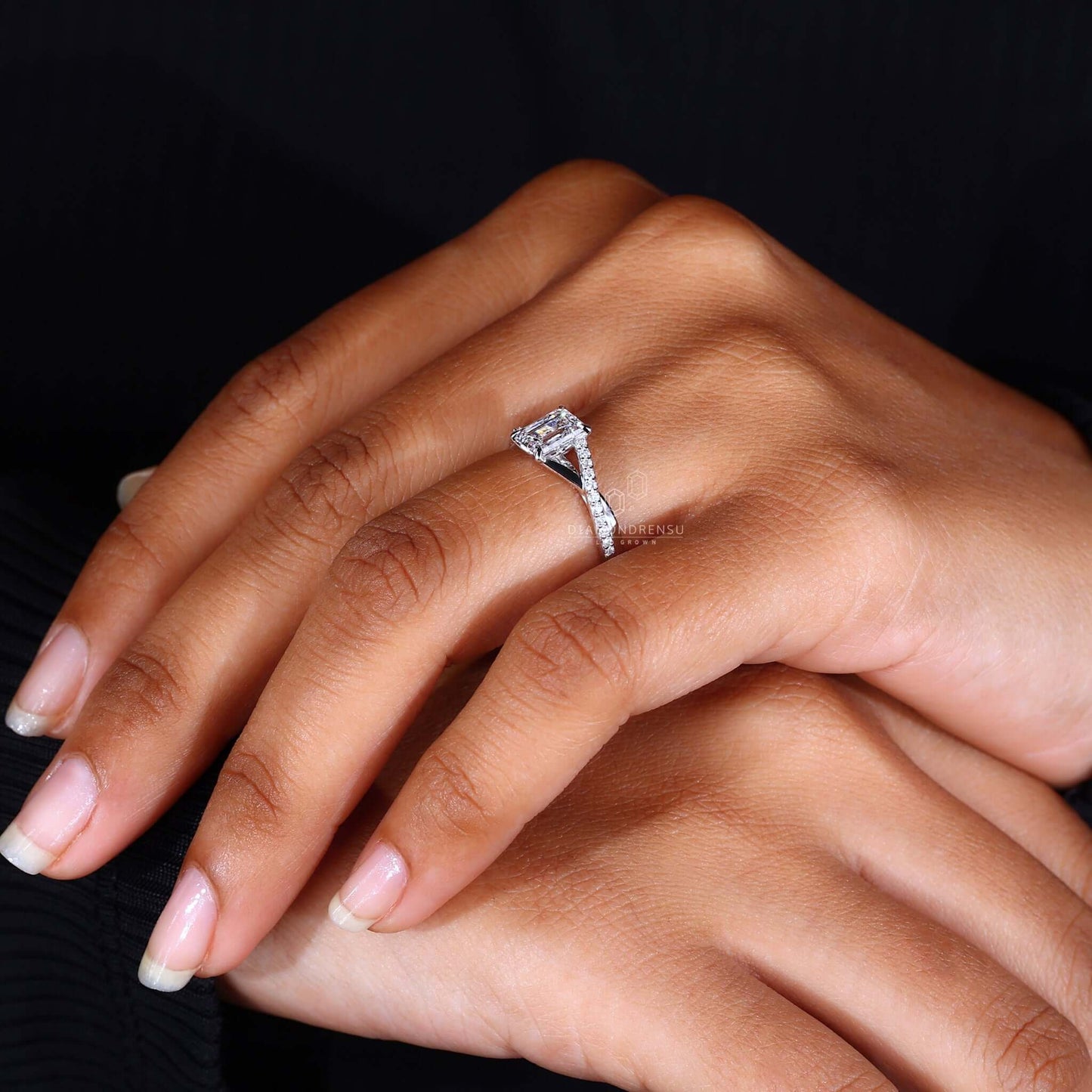 Lab-grown emerald cut diamond ring on a velvet cushion, representing sustainable luxury.