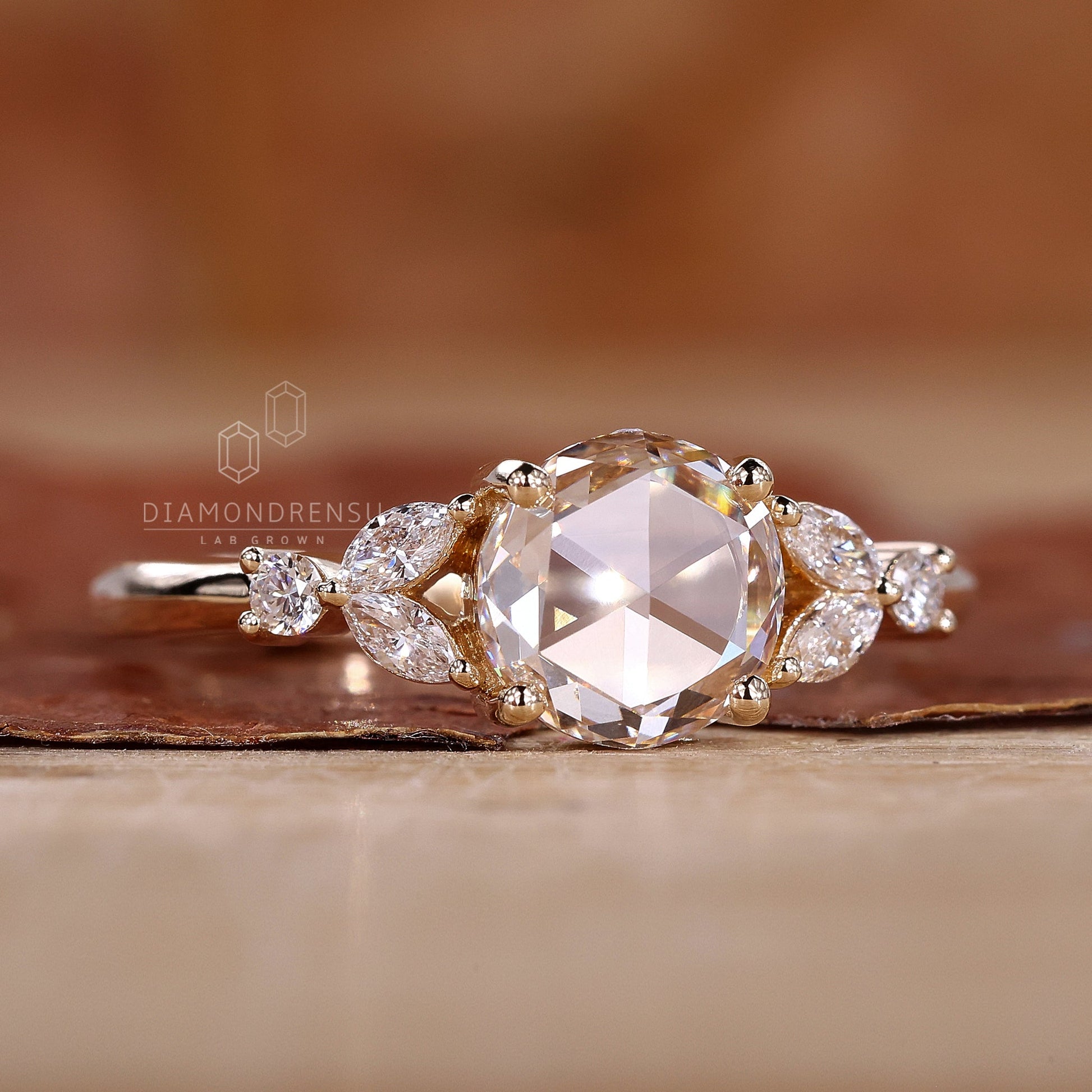 A side stone engagement ring featuring marquise and round side stones.