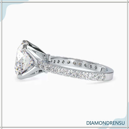 Round cut diamond engagement ring with pave ring details for added sparkle.
