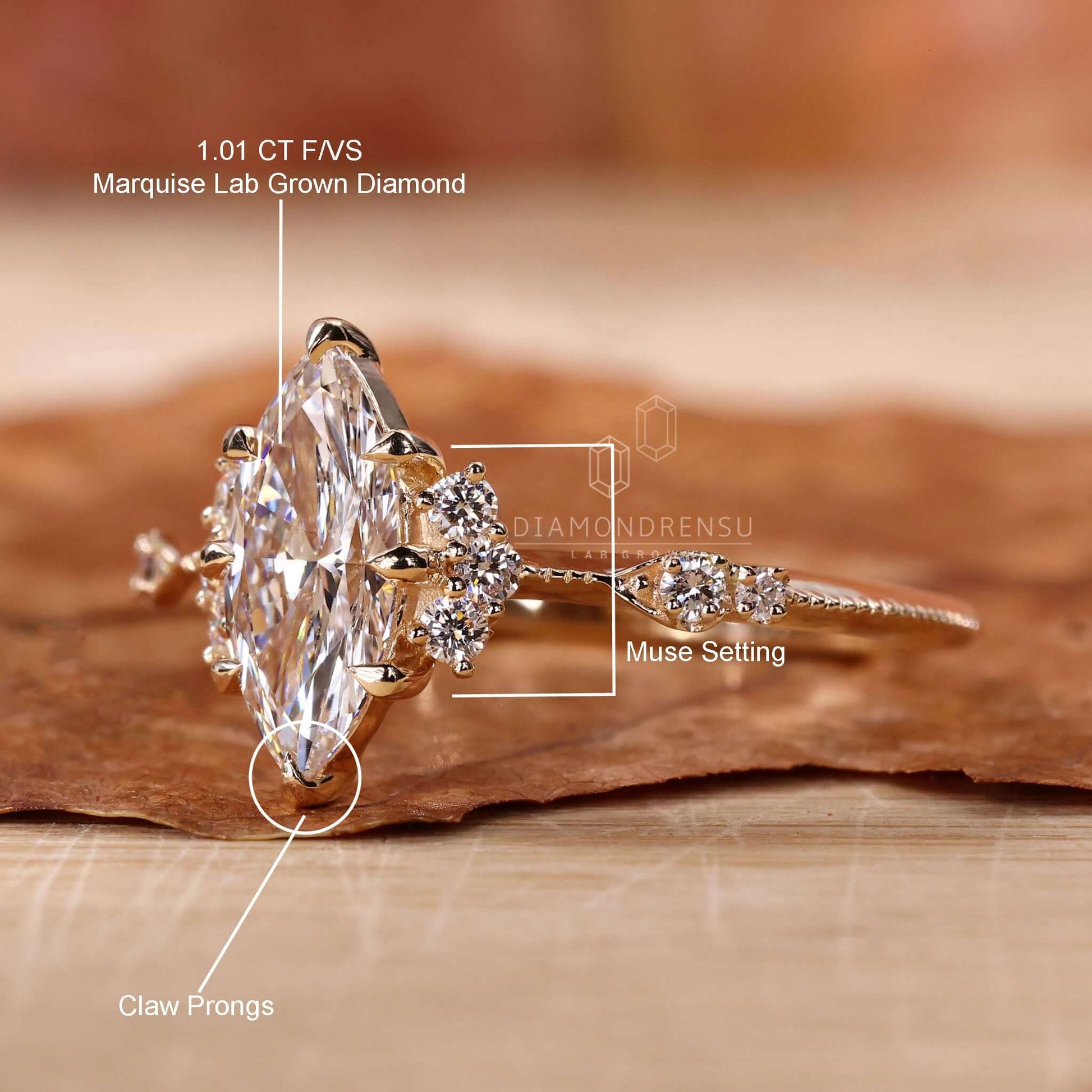 A handcrafted marquise cut diamond engagement ring with vintage charm, featuring round sidestones, knife edge band, and intricate miligrain work.