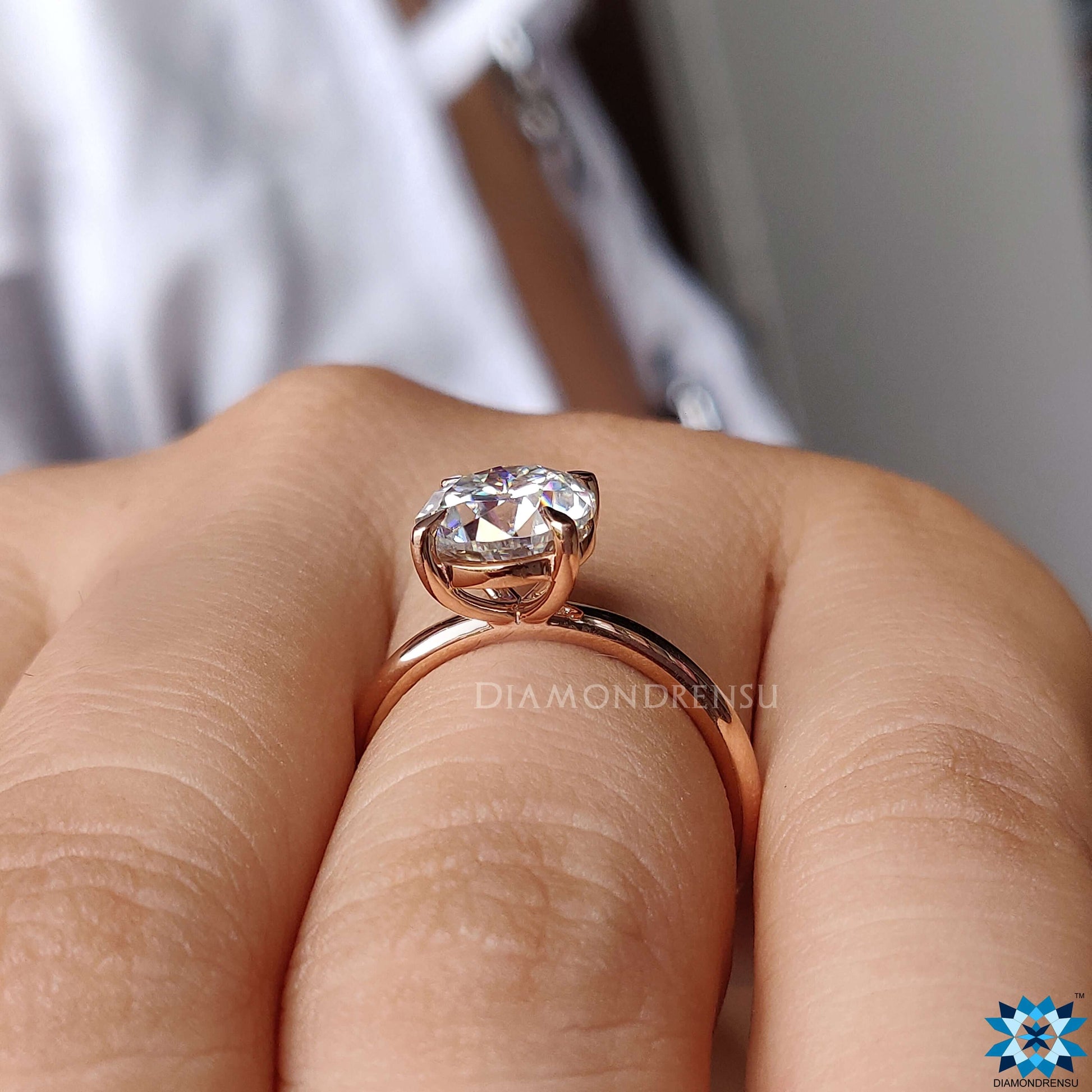 A captivating round moissanite engagement ring set in a sleek 4 prong ring setting, emphasizing the stone's brilliance.
