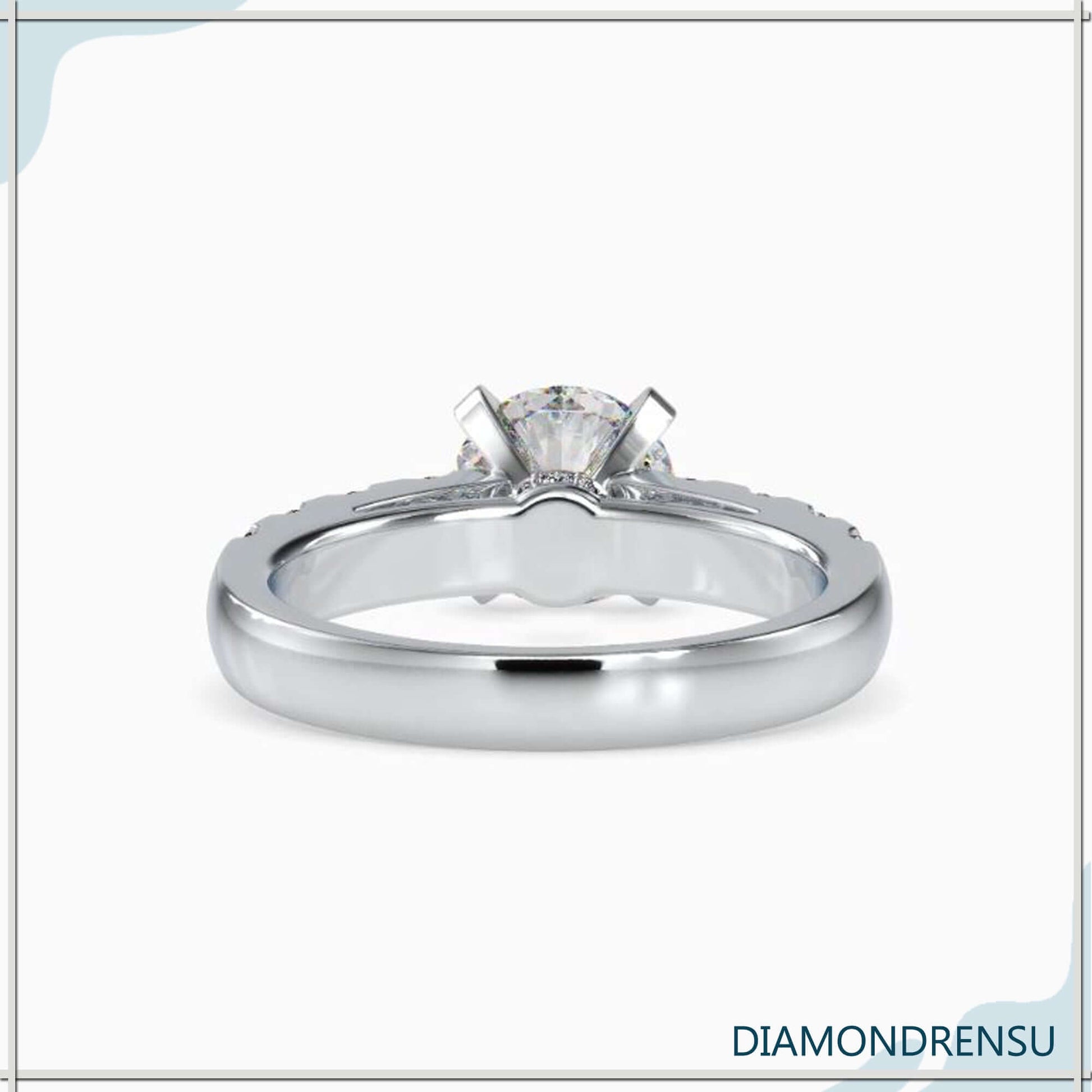 Handmade round cut engagement ring with a prong setting and Diamondrensu design.
