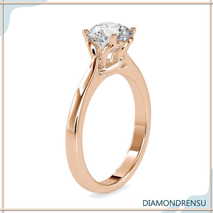 Classic round solitaire engagement ring with a twisted basket setting for modern elegance.