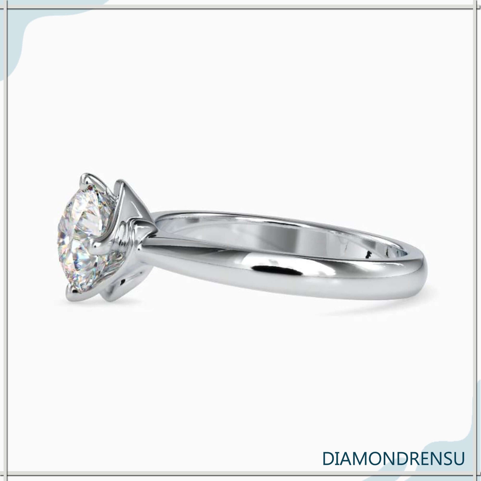 Four prong solitaire setting with round diamond for engagement.