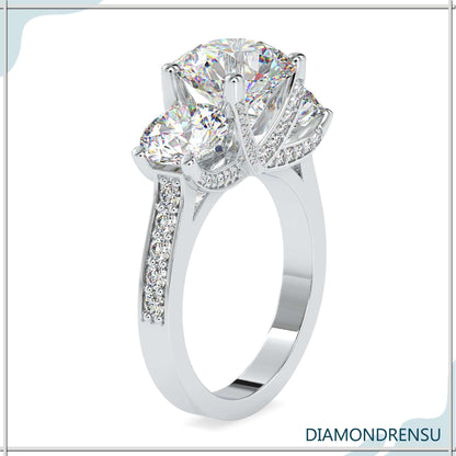 Three stone engagement ring with a classic round cut diamond center.
