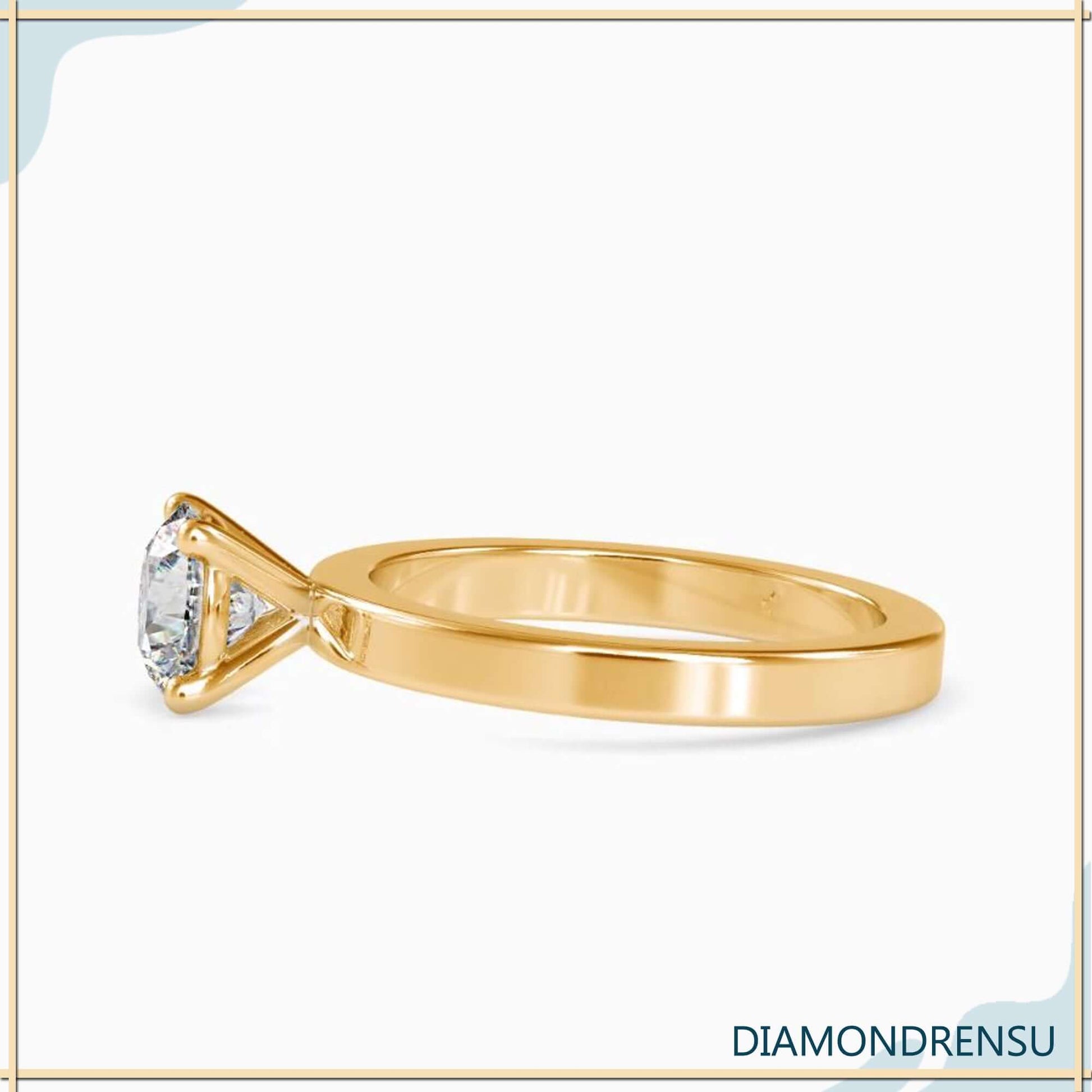 Elegant gold round ring with a solitaire diamond set in a classic basket setting.