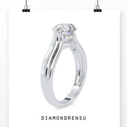 Round solitaire engagement ring in tension setting design.